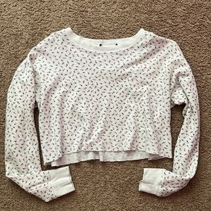 Cropped long sleeve shirt with pink flowers.